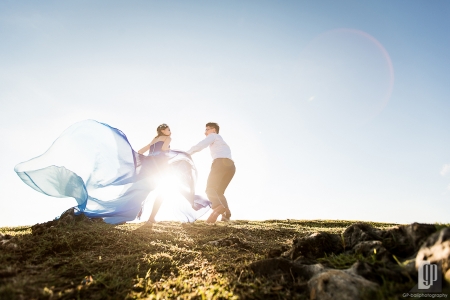 prewedding in tegal wangi beach bali smile happy sunset with love couple majestic beautiful cave and cliff waves blue gown and shirt green grass