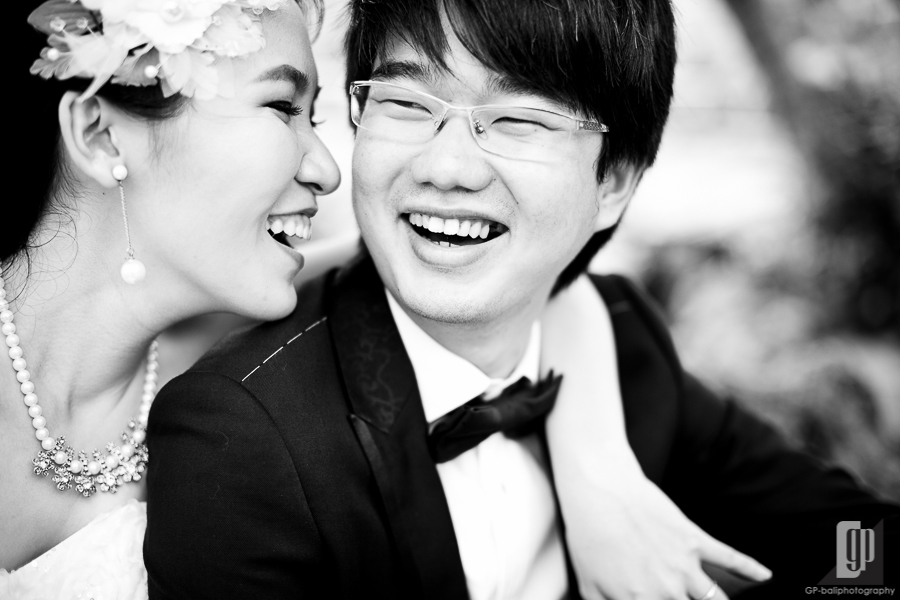 prewedding in ubud bali love happy laugh daylight gorgeous white dress and tuxedo hug from behind