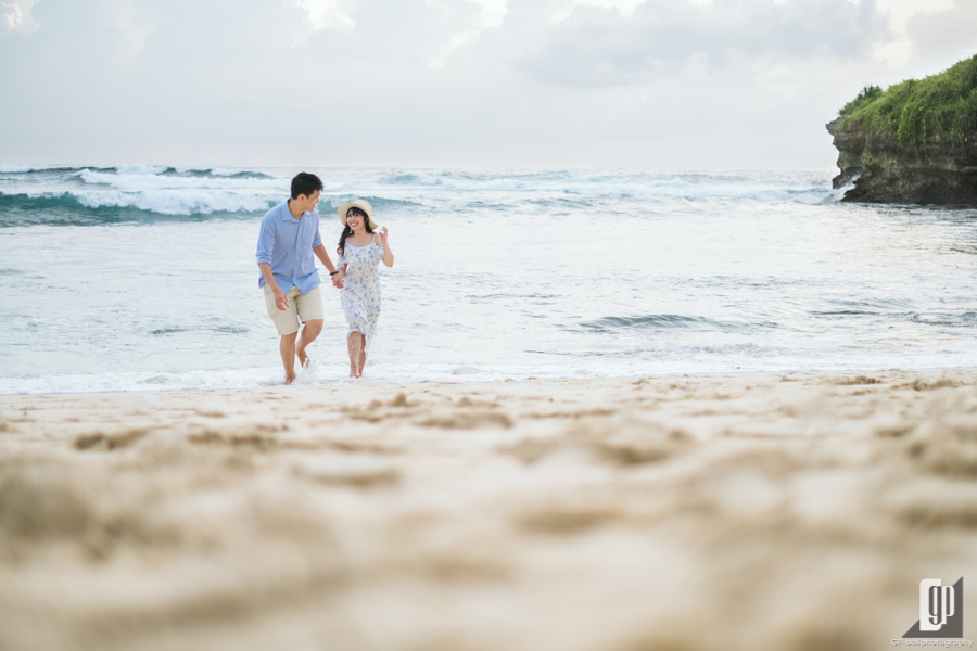 Prewedding in Lembongan Island Bali happy love smile daylight beach with blue sky wind and sea casual hug kiss waves water sand