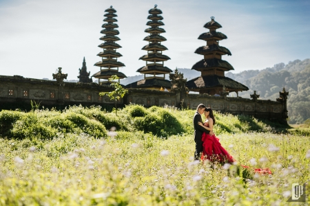 prewedding in tamblingan lake bali engagement with red dress and tuxedo look each other tamblingan temple hug kiss couple