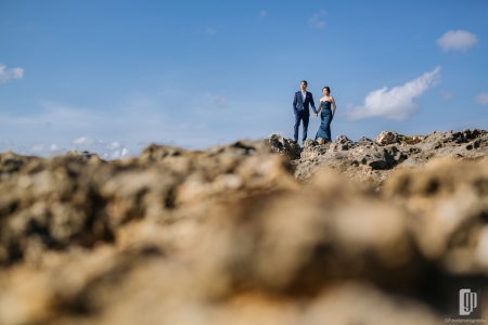 prewedding in tegal wangi beach bali love happy smile couple cave rock beach cliff blue sky