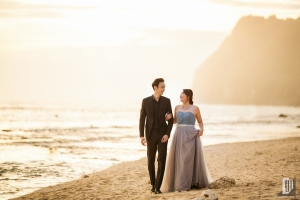 Prewedding in Melasti Beach Bali happy love smile happy sunset romantic hug kiss gray dress and tuxedo cliff