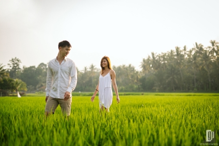 Prewedding in Bali happy love smile sunset with orange sky wind with white dress and white shirt casual