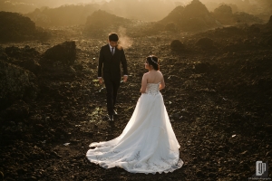 Prewedding in Mountain Batur Bali happy love smile white gown and tuxedo crown sunrise stone larvae